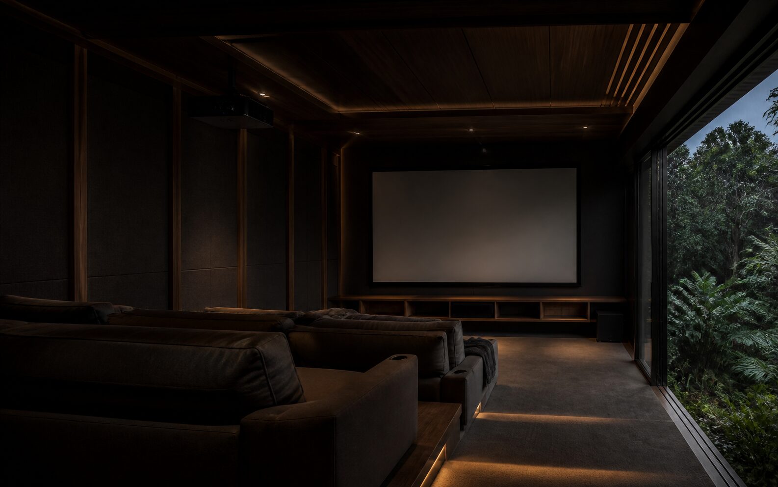 Conceptual private cinema in a Kerala home with warm timber detailing, a blank screen and tropical greenery beyond.