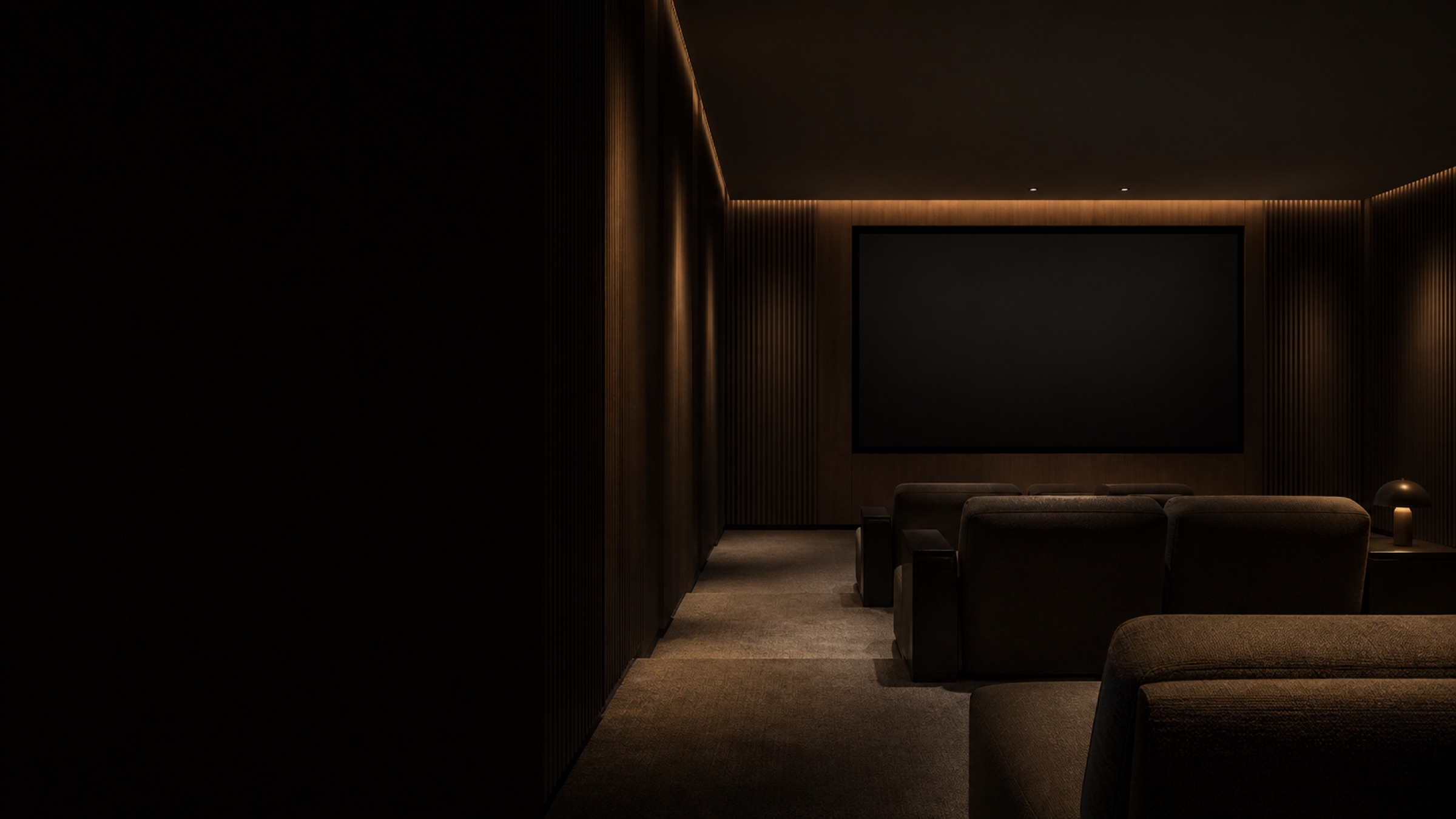 Conceptual finished private cinema with a dark screen, low seating and subtle cove lighting