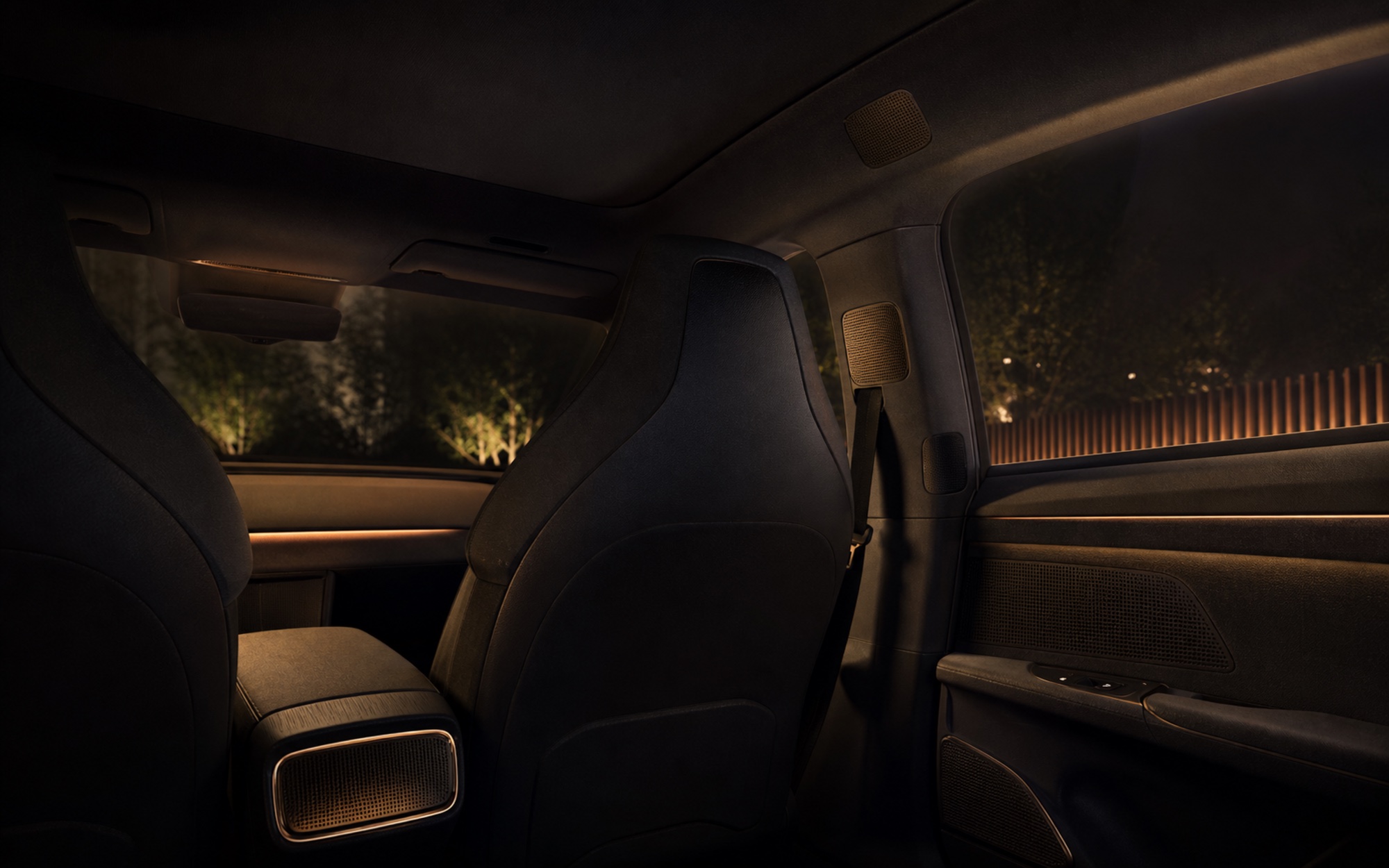 Conceptual premium vehicle cabin with discreet integrated audio and entertainment controls.