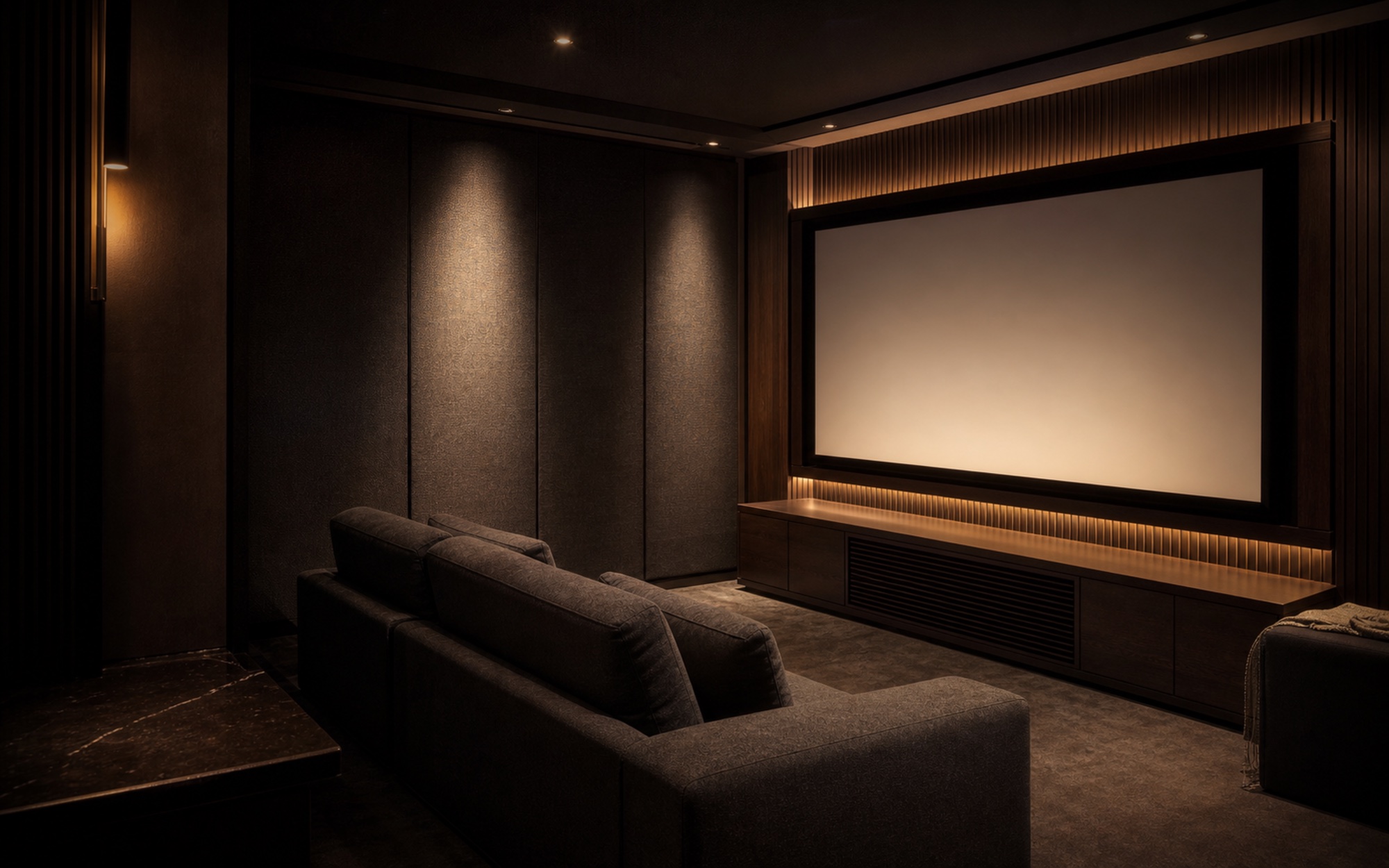 Conceptual compact private cinema with a focused screen, restrained seating and carefully integrated equipment.