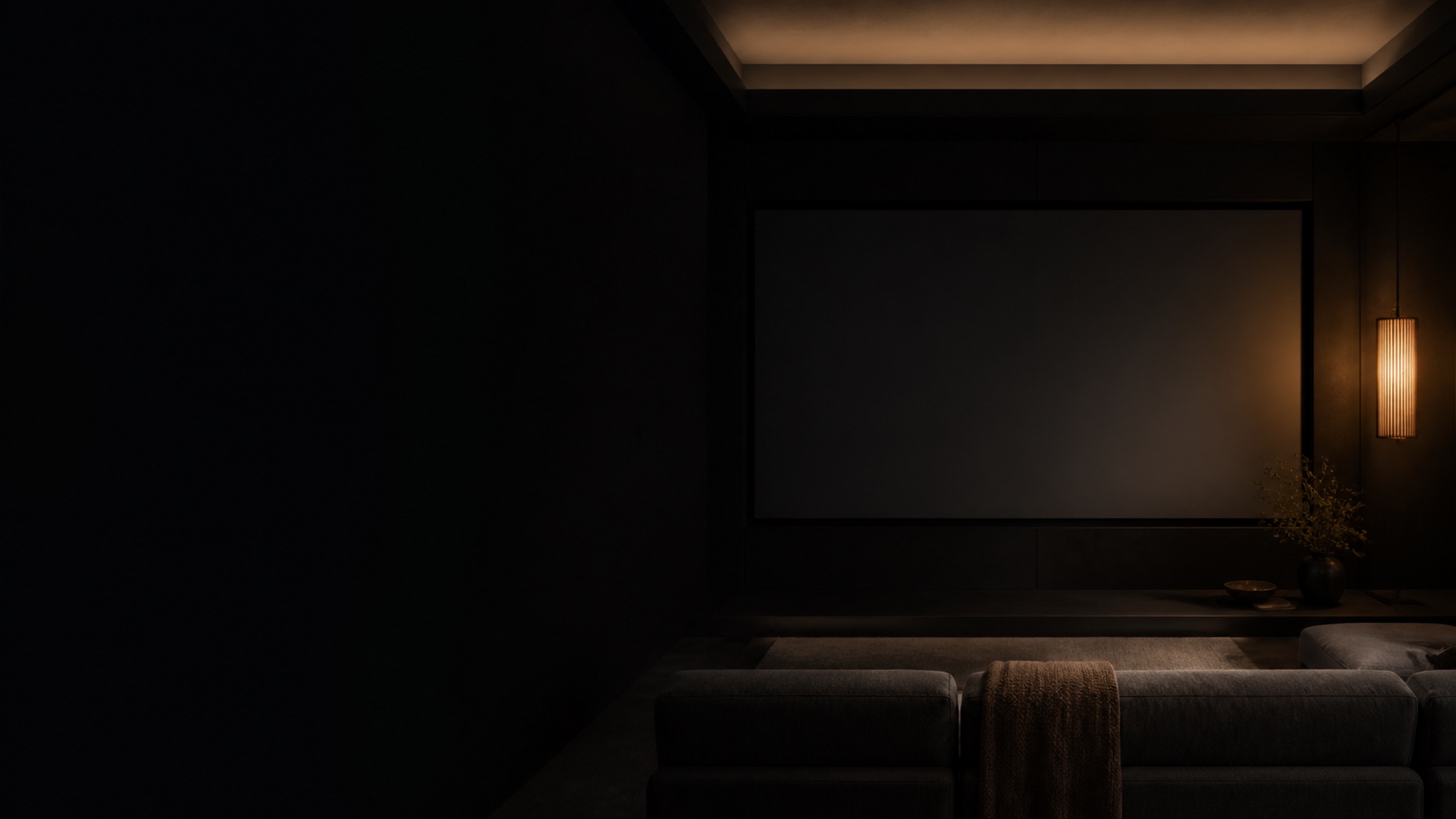 Conceptual private cinema interior with a dark screen, low seating and warm practical lighting